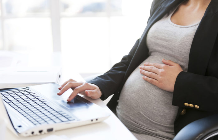 Pregnant Woman Working On Laptop.